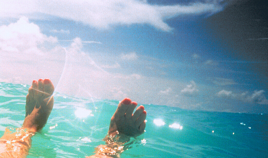 Female feet in ocean