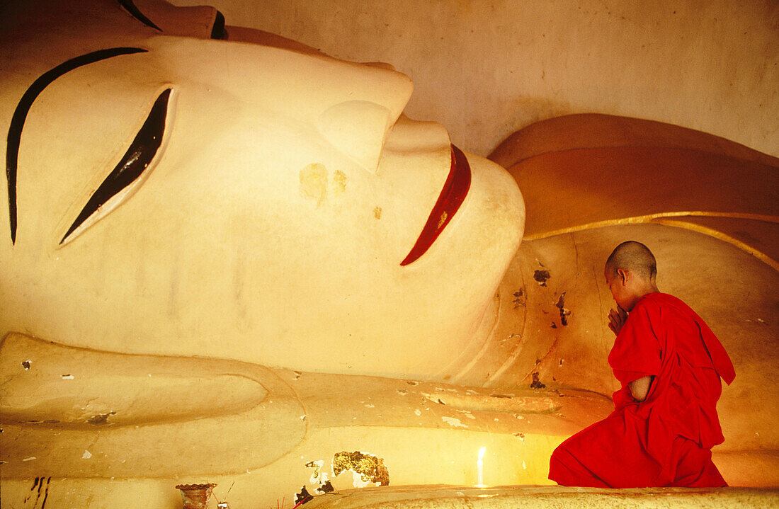 Novice monk praying buddha. Bagan. Myanmar (Burma)