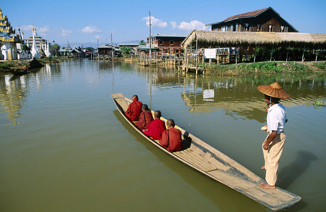 Monk on boat for alms. Inle Lake. Shan State. Myanmar.