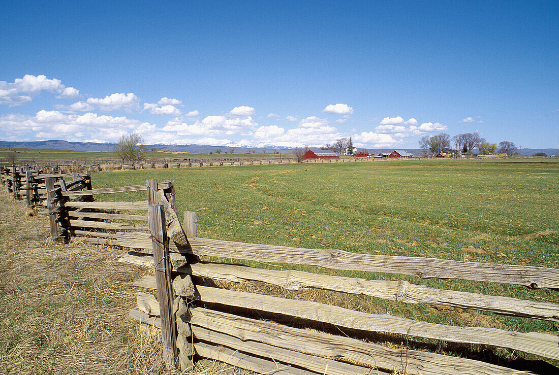 Wooden fence and ranch along the Powder River under the Wallowa Mountains. Eastern Oregon. USA