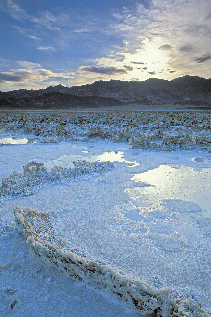 Flooded salt pan under the Amargosa Range at dawn, Death Valley National Park, California
