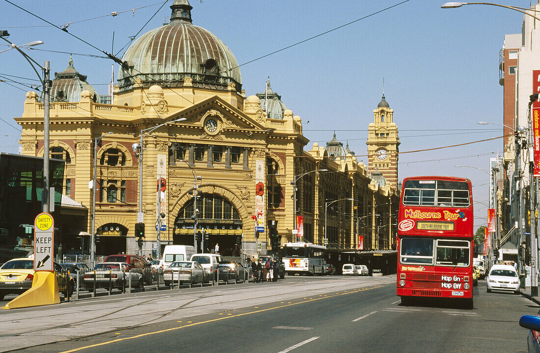 Tourist bus passing Flinders Street Station in Melbourne (world s most liveable city, 2004), Australia