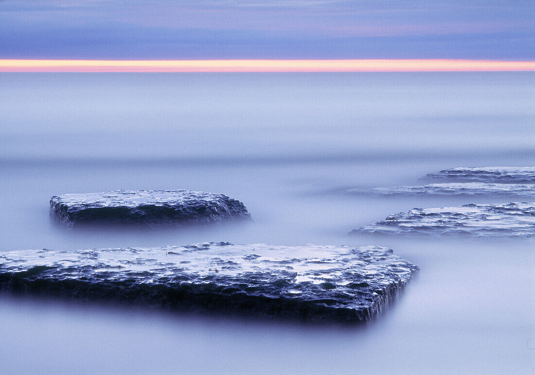 Limestone rocks in waters edge. Byrums Raukar at Öland Island in Kalmar Sound, Sweden.