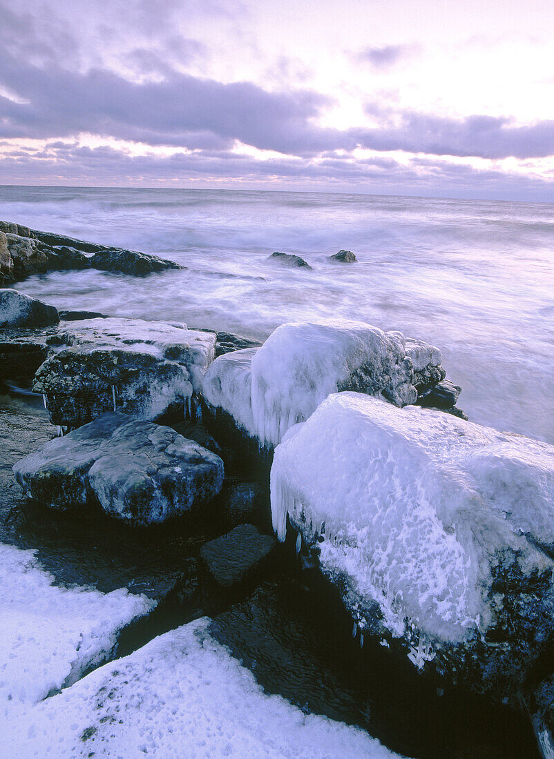 Ice and stones by the shoreline of Baltic Sea. Skåne. Sweden