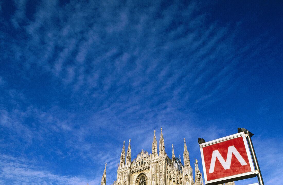 Cathedral and subway sign. Milan. Italy