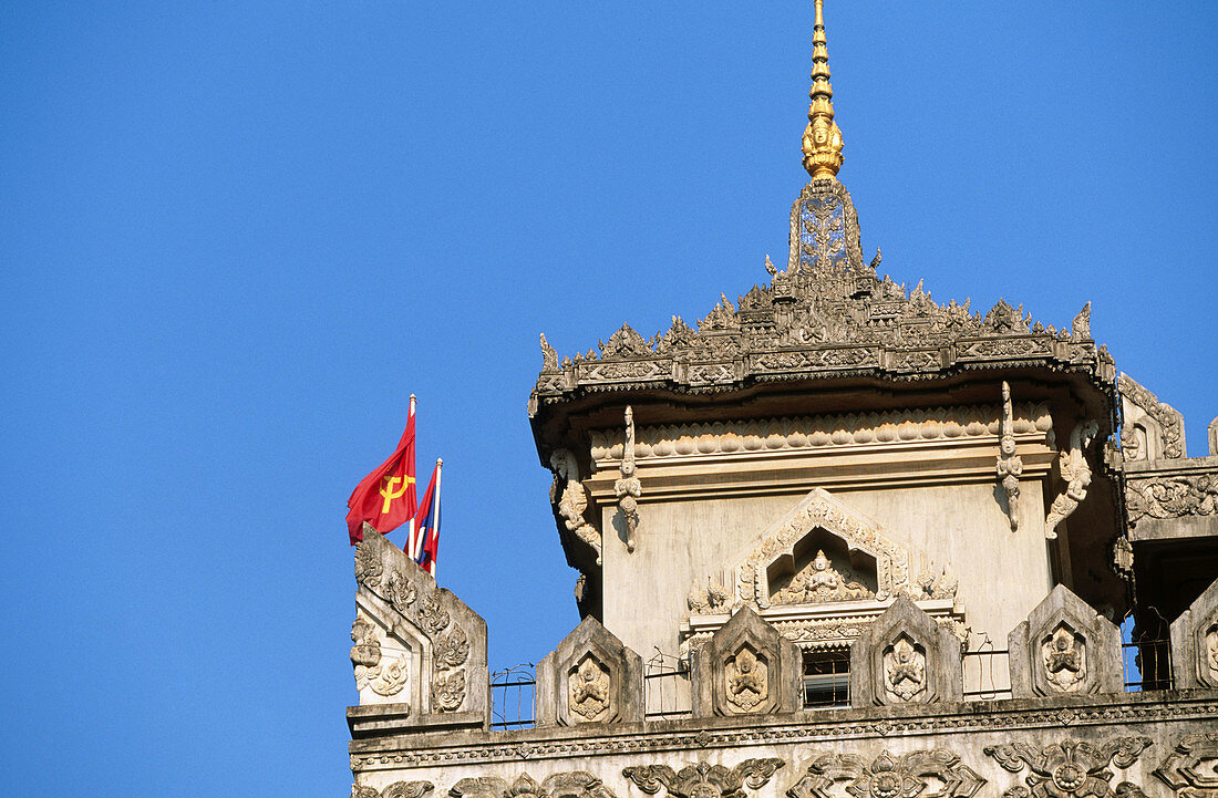 Communist and Laotian flags over Patouxai arch. Vientiane. Laos