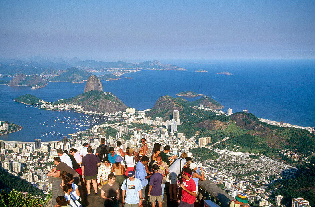 Tourists in Mount Corcovado contemplating Rio de Janeiro from above. Brazil