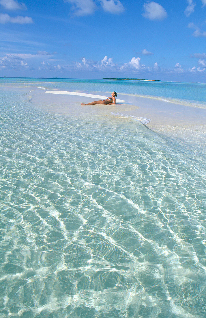 Woman on the beach in White Sands Resort and Spa. Ari Atoll. Maldives