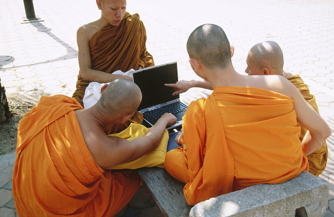 Monks with computer. Temple Wat Suan Dok. Chiang Mai. Thailand