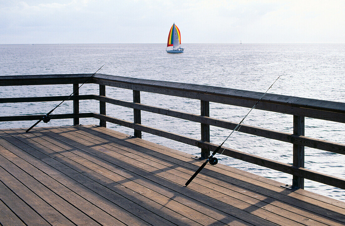 Distant sailboat and fishing dock