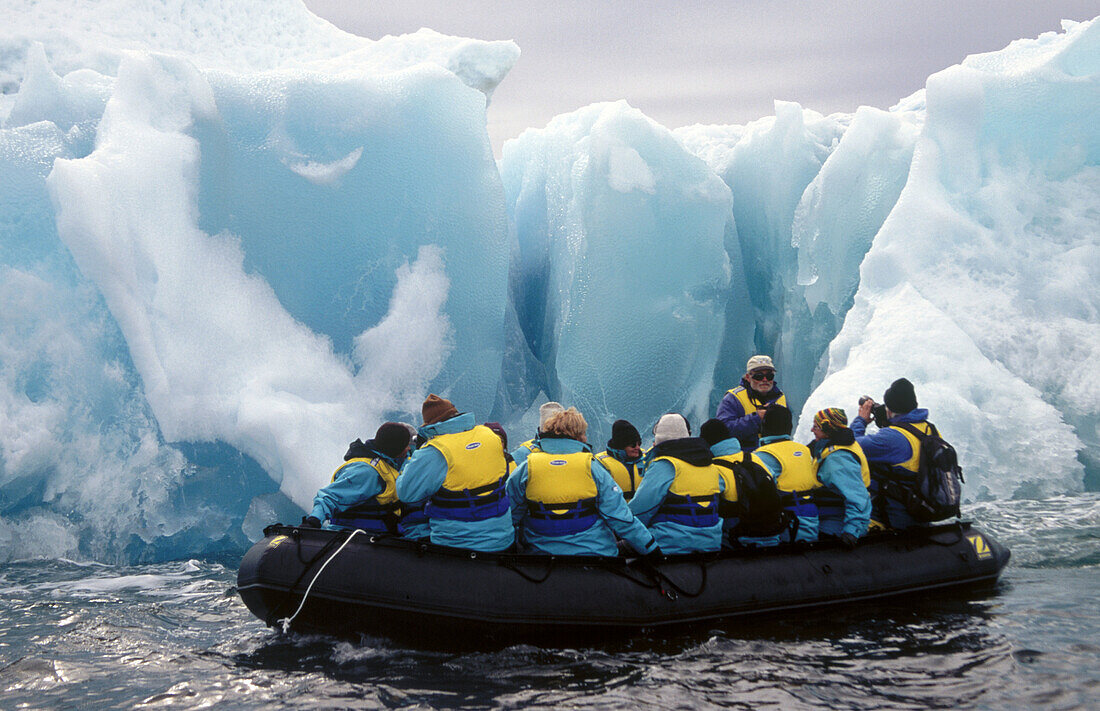 Zodiac with tourists. Past Jade coloured iceberg. Dumont d Urville, Antarctica.