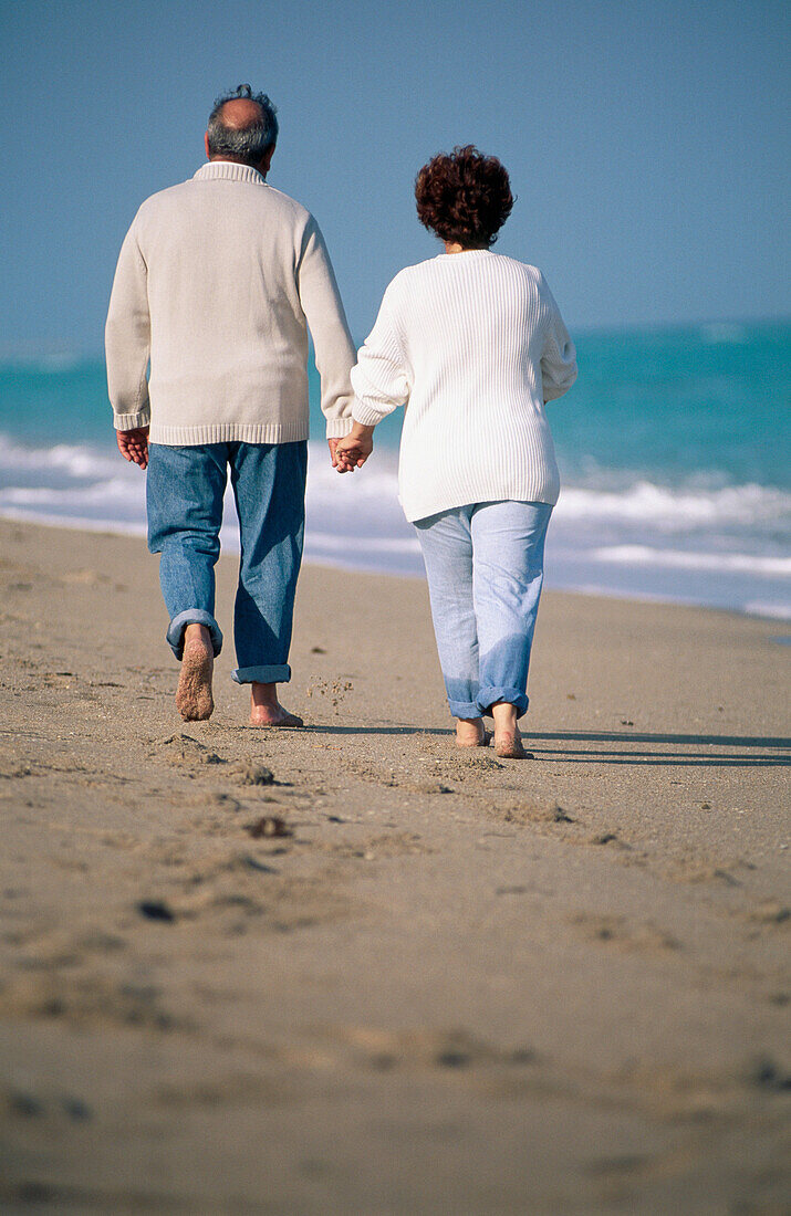 Mature couple walking on the beach