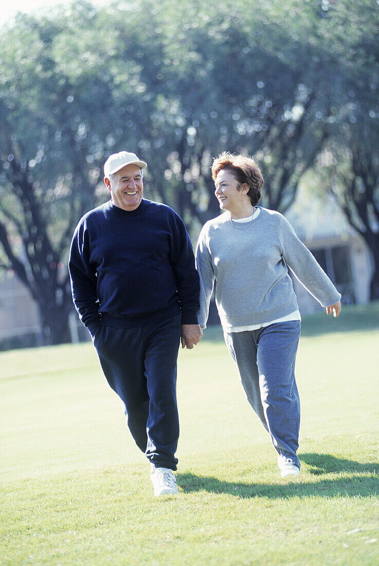 Mature couple walking outdoors in sportswear, Florida