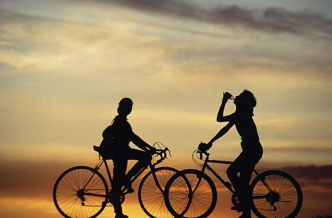 Girls in bike at sunset