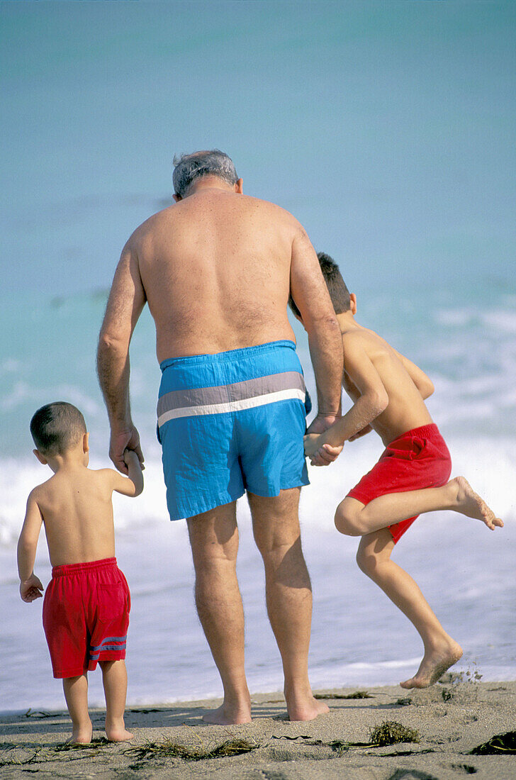  60 to 70 years, 60-65 years, 60-70 years, Amusement, Back view, Bathing suit, Bathing suits, Beach, Beaches, Boy, Boys, Brother, Brothers, Caucasian, Caucasians, Child, Children, Coast, Coastal, Col