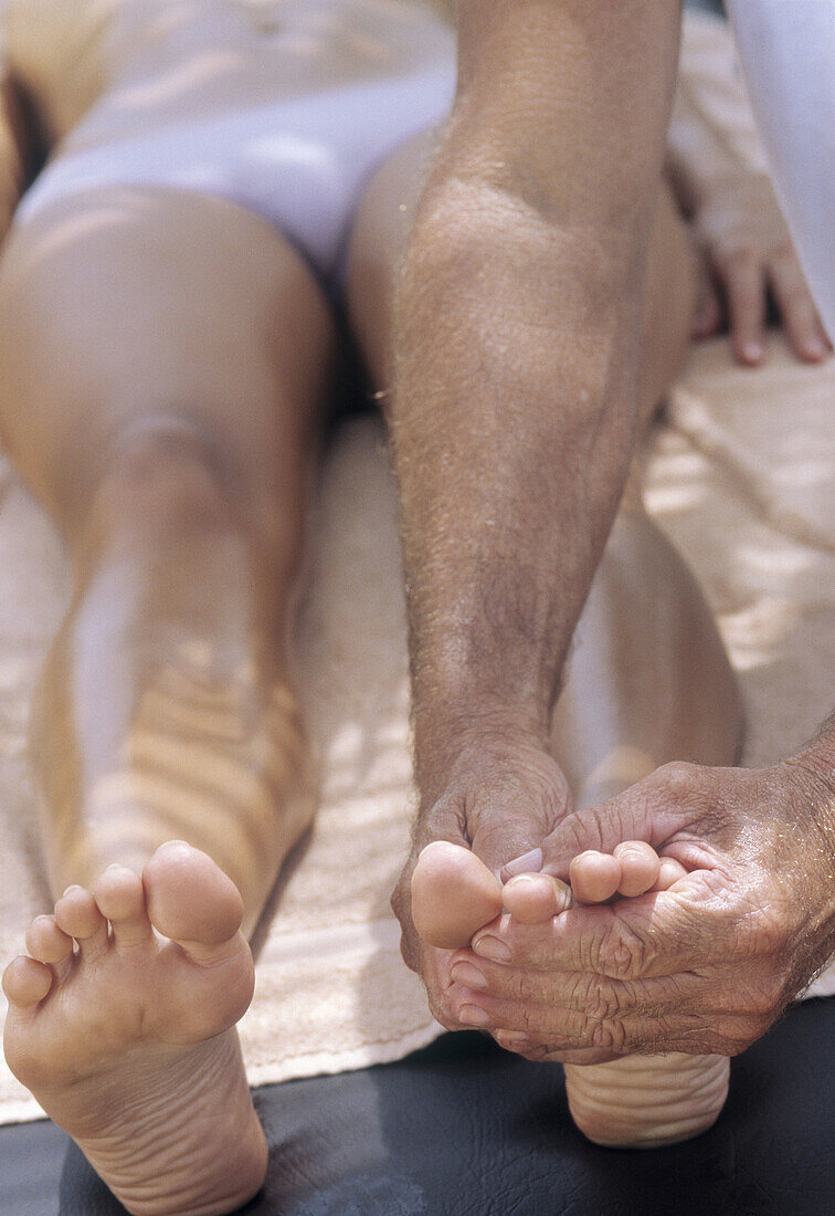 Woman getting a foot massage outdoor in a spa