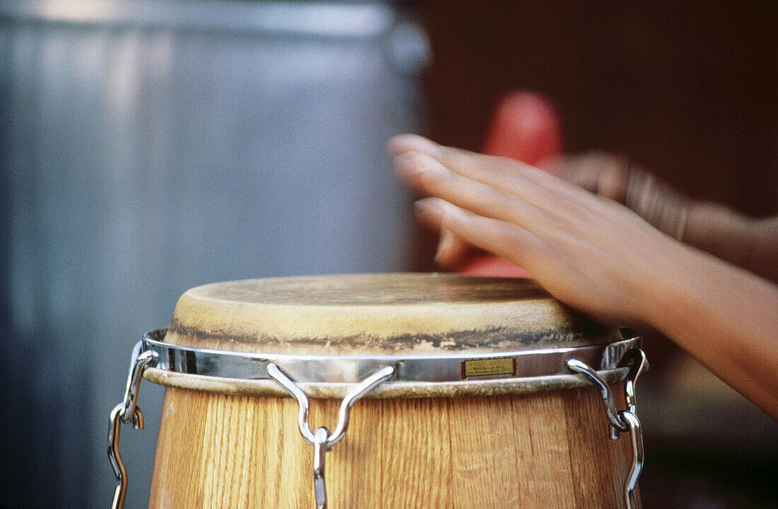 Hands playing conga drums