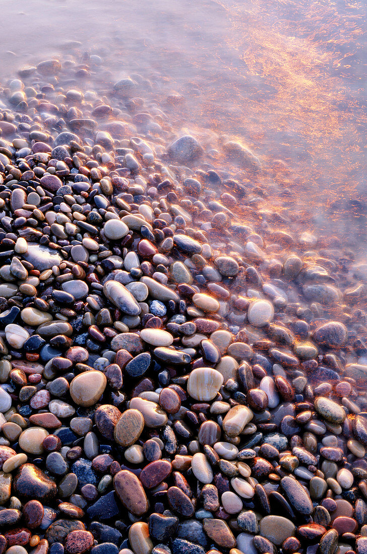 Colorfull rubble stones at waters edge, by the Baltic Sea. East coast of Skåne, Sweden.
