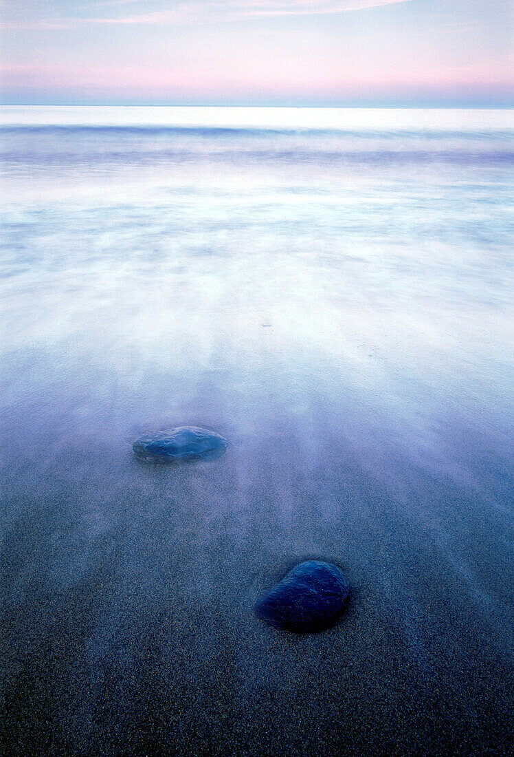 Stones, Alun shale, at waters edge, by the Baltic Sea. East coast of Skåne, Sweden.