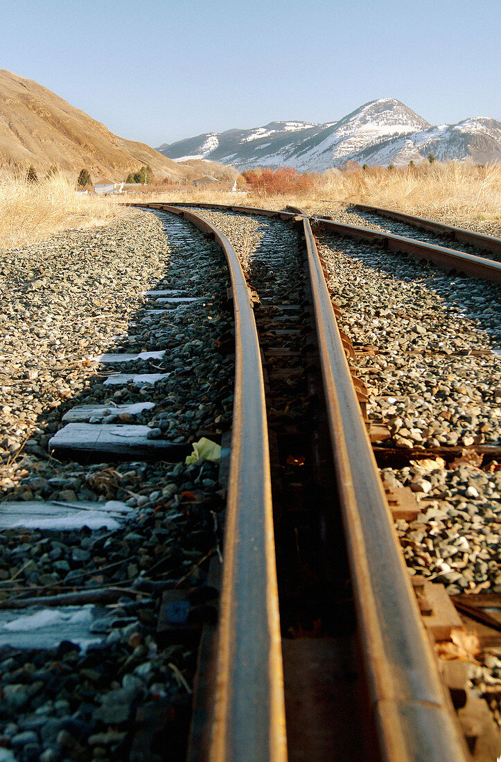 Railroad tracks with mountains in background