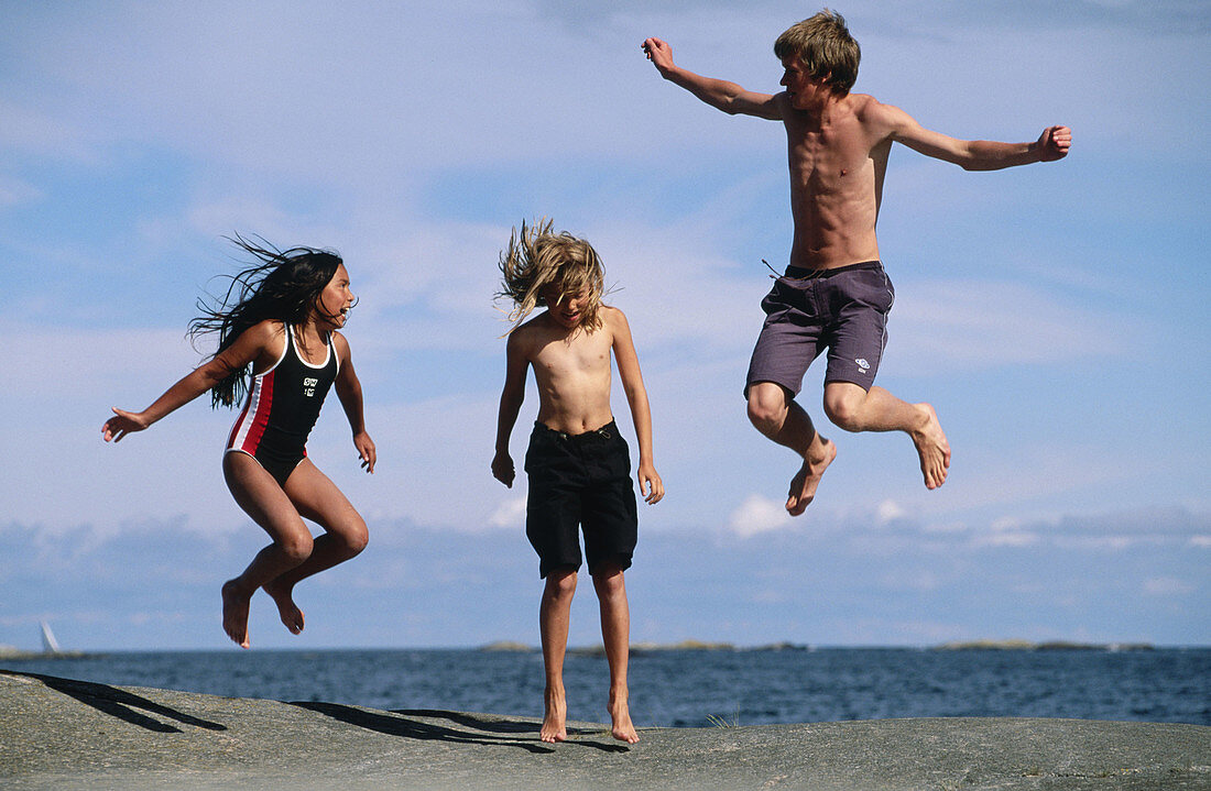 Three children jumping