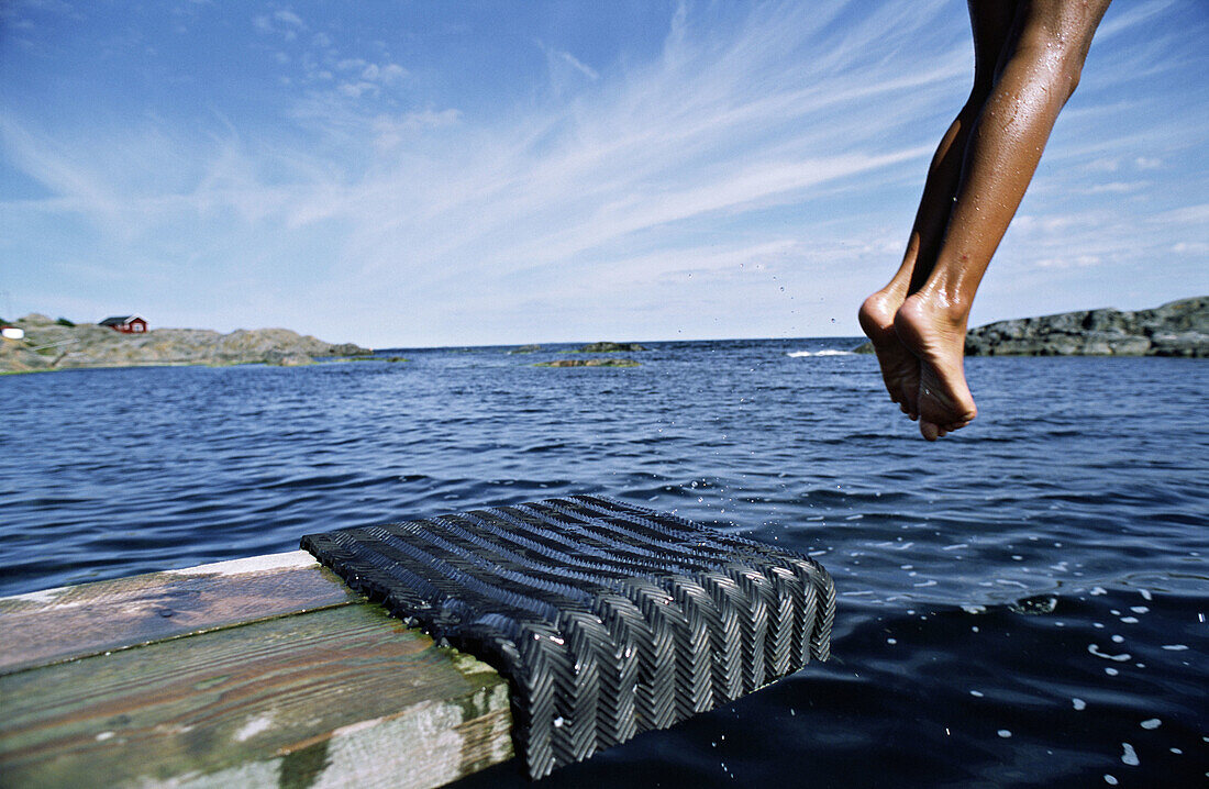 Boy jumping off dock. Matton. Sweden.