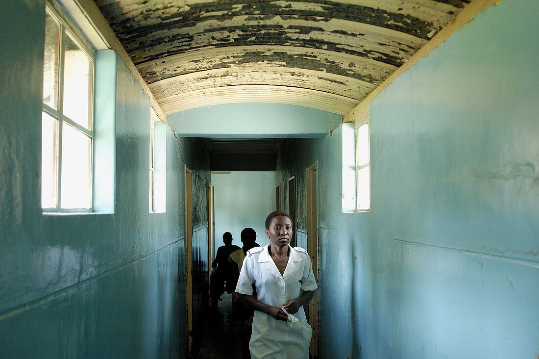 A nurse walks the hallway from the Howard Hospital Emergency to the Male Ward. The eighty year old salvation Army operated facility sometimes shows its age. The Hospital is located in northern Zimbabwe.