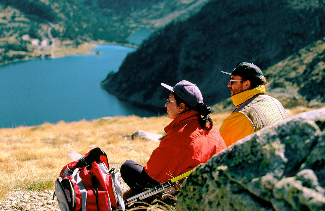 Hikers contemplating the landscape in Neouvielle Natural Park. French Pyrenees.