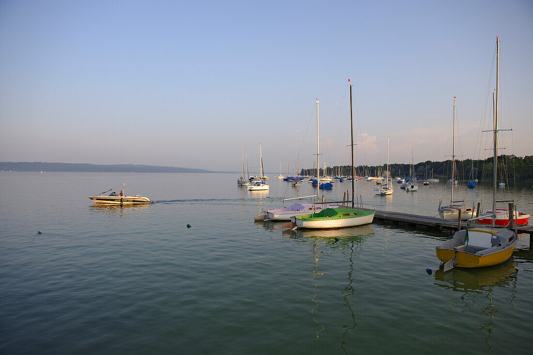 Boats on lake Staffelsee in the evening light, Utting, Bavaria, Germany