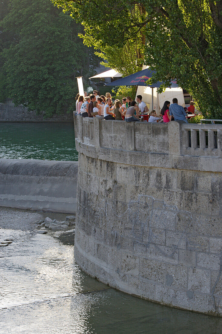 People enjoying themselves at a beach bar at the Museumsinsel, Munich, Bavaria, Germany