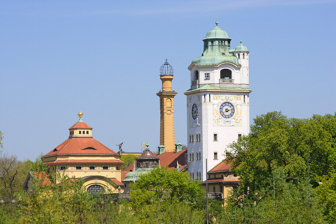 Roof and water tower of Müllersches Volksbad over tree tops, Munich, Bavaria, Germany