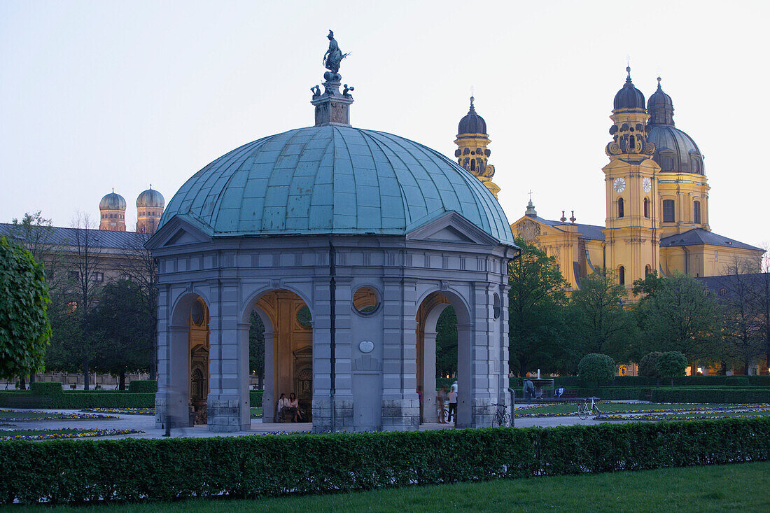 Pavillion at Hofgarten, the onionshaped towers of Frauenkirche and Theatinerkirche in the background, Munich, Bavaria, Germany