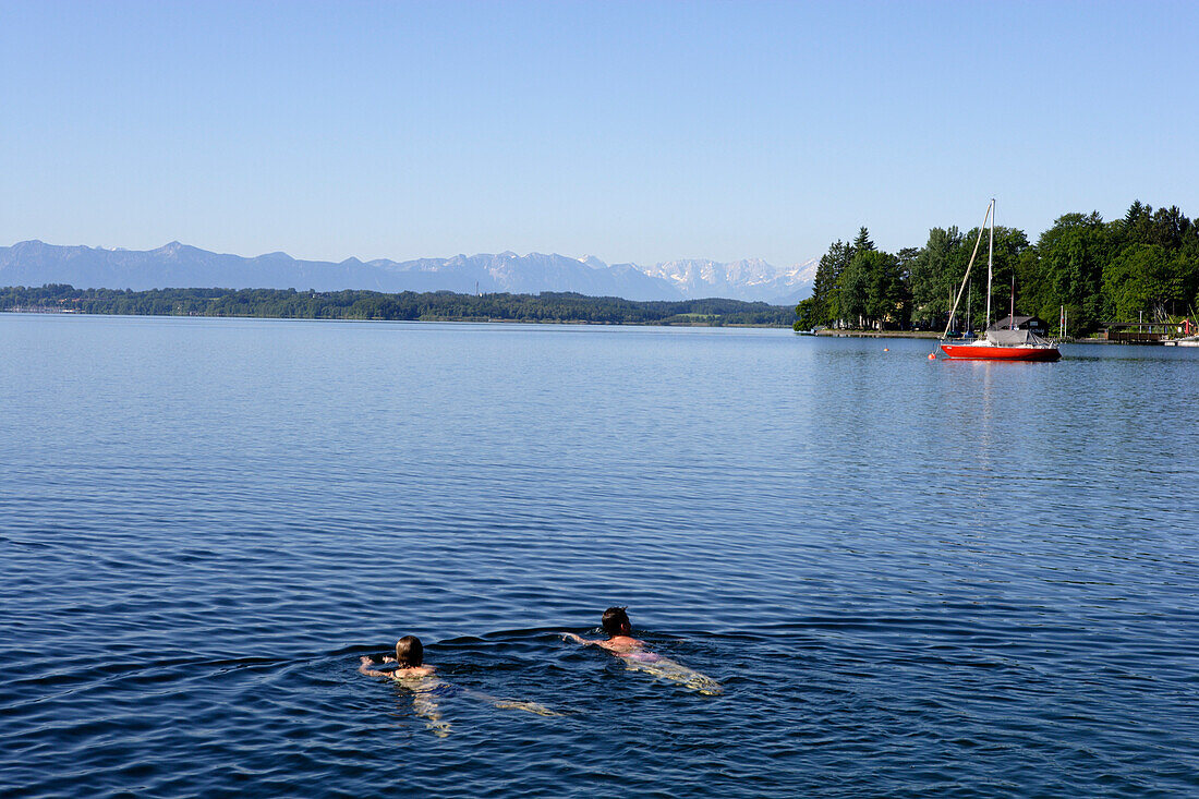 A couple swimming in lake Starnberg, Tutzing, Bavaria, Germany