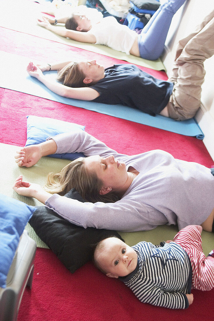 Mothers in post natal yoga class with their babies