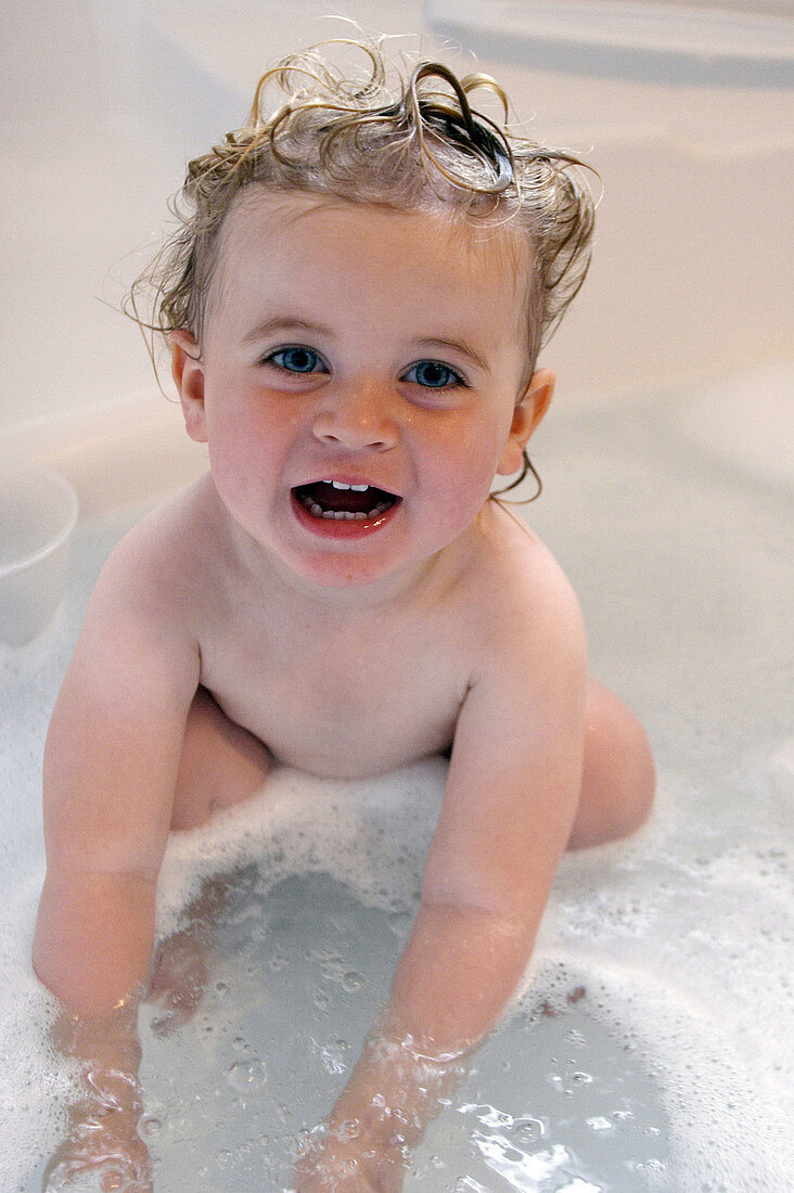 2 year old girl in the bath ,smiling into camera