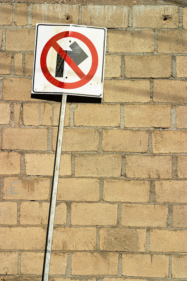 Traffic sign, no right turn in front of brick wall. Cabo San Lucas, Mexico