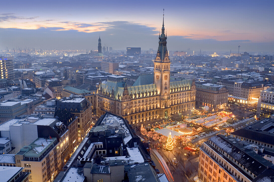 Christmas Market, city, and City Hall at night. Hamburg, Germany.