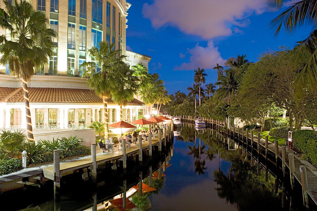 People sitting on the illuminated terrace of the Wild East Grill restaurant in the evening, Fort Lauderdale, Florida, USA