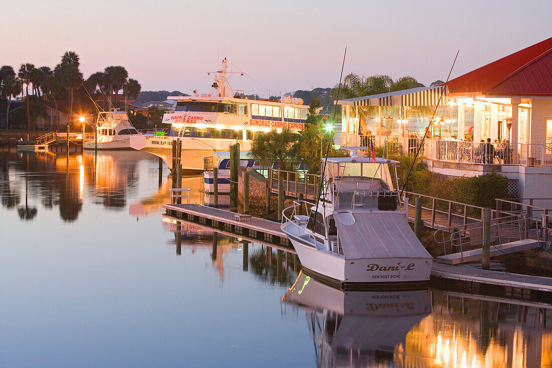 The illuminated Catches Waterfront Grille restaurant on the waterfront in the evening, Tampa Bay, Port Richey, Florida, USA