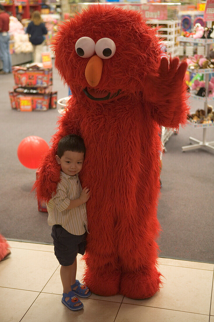 Little boy and Sesame Street figure at a shop, Sawgrass Mills Outlet Mall, Miami, Florida, USA