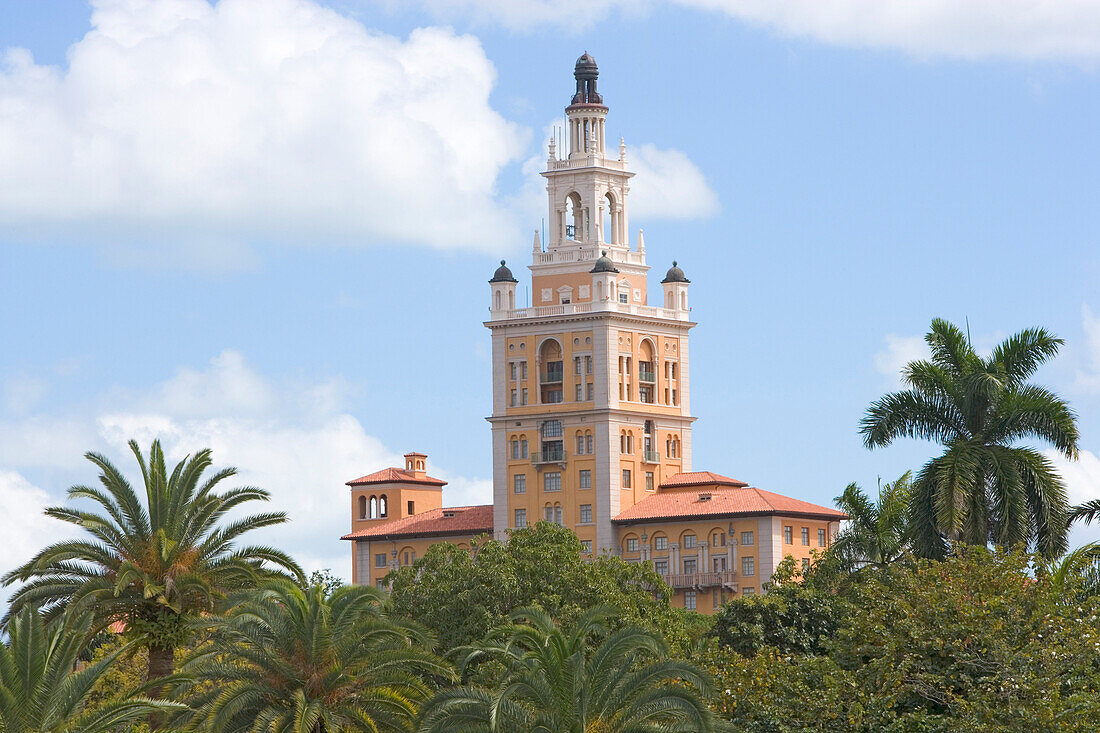 The tower of the Biltmore Hotel above tree tops, Miami, Florida, USA