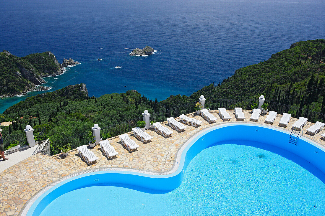 View of the pool of Golden Fox Hotel, coastal landscape in the background, Corfu, Ionian Islands, Greece