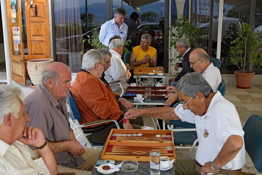 Mature men playing backgammon in a cafe, Corfu, Ionian Islands, Greece