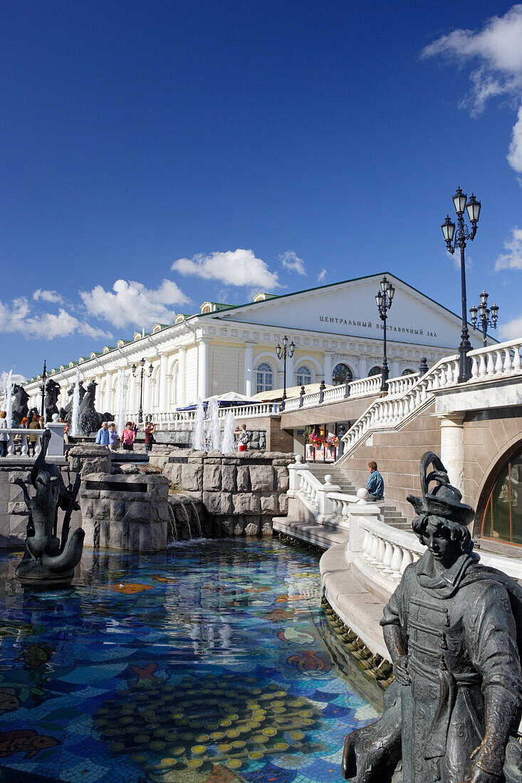 Waterworks between Alexander garden and Manege square with the Manege building in the back, Moscow, Russia