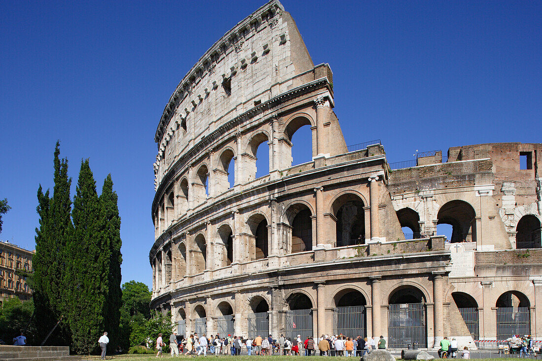 Tourists in front of the Colosseum under blue sky, Rome, Italy, Europe