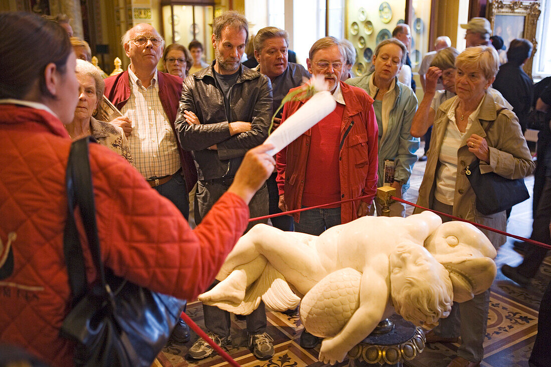 Tour guide and visitors in the Hermitage in the Winter Palace, Saint Petersburg, Russia