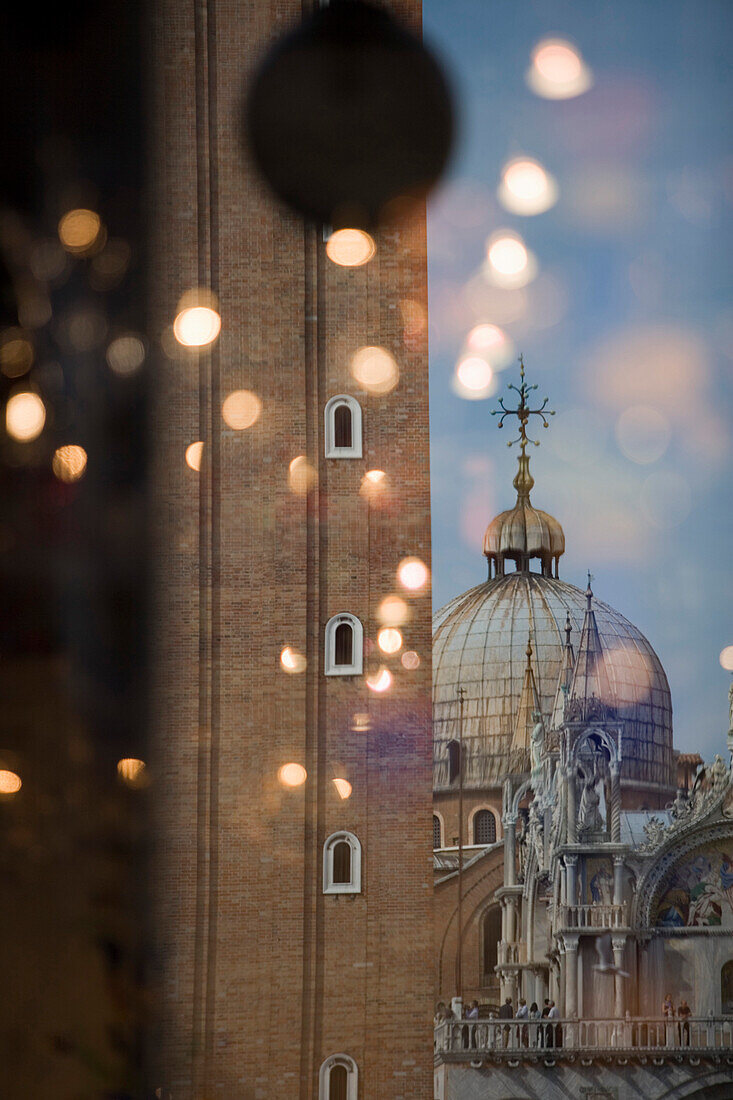 Shop window reflection of Campanile tower and St Mark's Basilica Cathedral on Piazza San Marco, Venice, Veneto, Italy