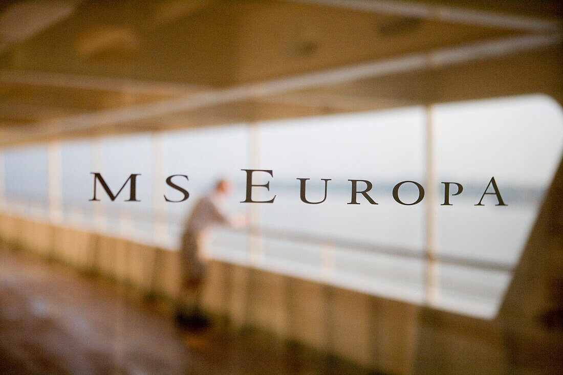 Window of the MS Europa, man leaning over the reeling of the cruise ship, Atlantic Ocean, Brazil, South America