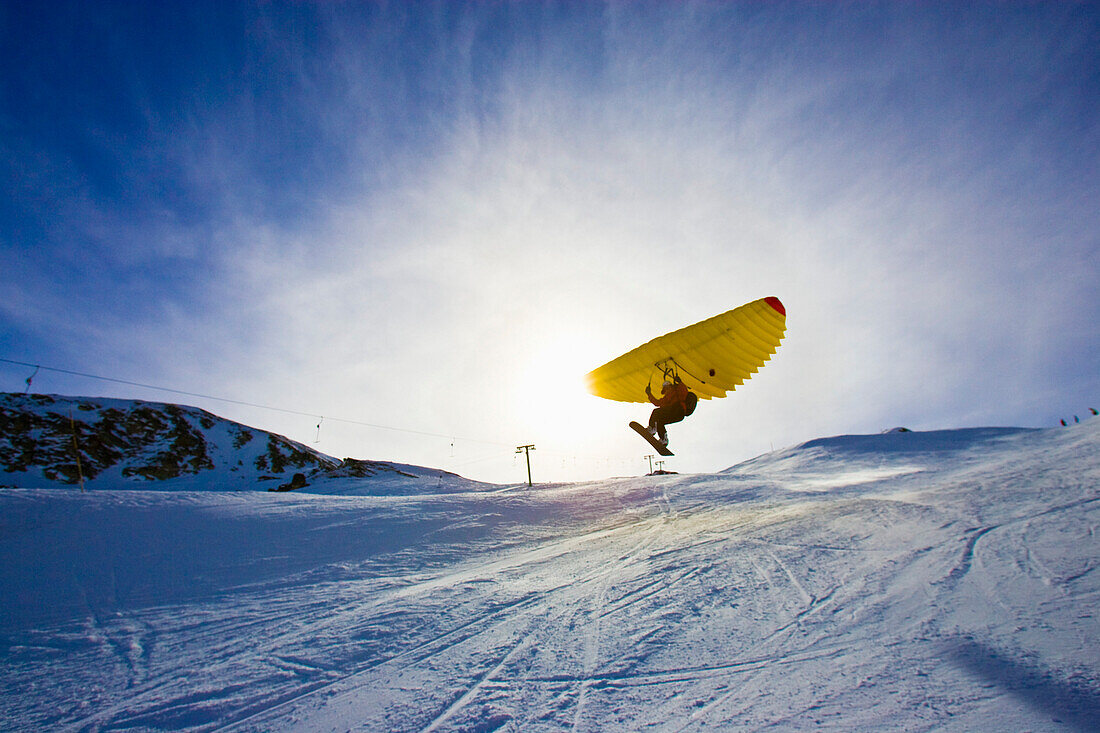 A man with snowboard using a Woopy-Jump, Grimentz, Valais, Switzerland