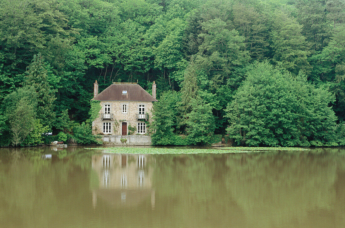 House at a lake in forest near Paimpol (Pempoull). Britanny. France.